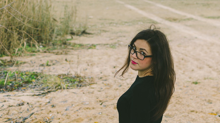 Woman on the beach of sea in autumn timeの写真素材