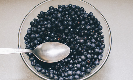 Blueberry in plate on the home kitchen tableの写真素材