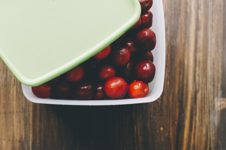 Fresh cherry in box on the wood tableの写真素材