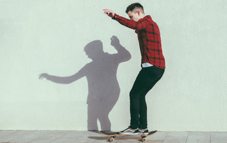Young man training ride on the skateboardの写真素材