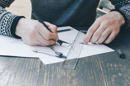 Man drawing a sketch on the papper on tableの写真素材