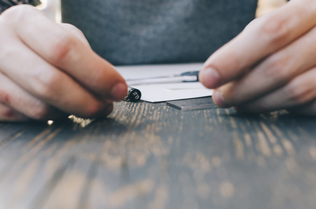 Man drawing a sketch on the street caffee tableの写真素材