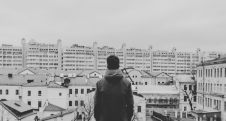 Black and white photo of the young man on the rooftop in the cityの写真素材