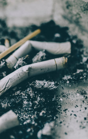 Cigarette butts on a gray dirty background