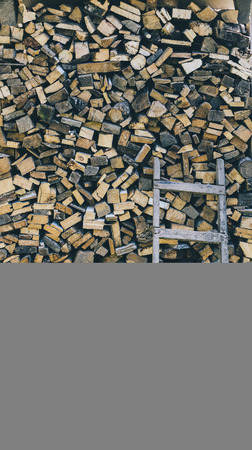 Firewood stacked in the yard. Harvested wood for the fireplace and the boilerの写真素材