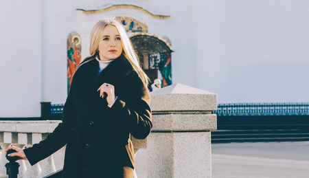 Beutiful young blonde girl on the city architecture streetの写真素材