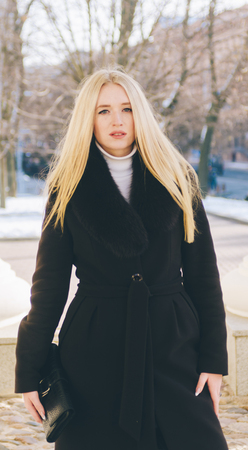 Portrait of the young blond pretty girl on city streetの写真素材