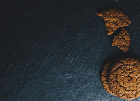 Oatmeal cookies on the black stone backgroundの写真素材