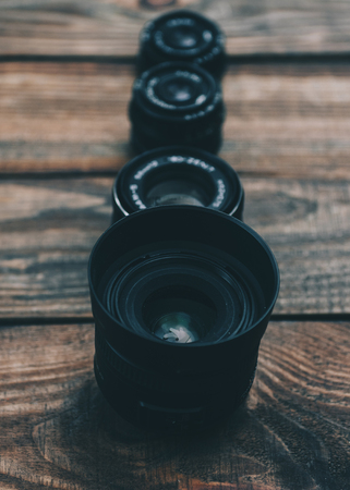Lens on the wooden table for dslr cameraの写真素材
