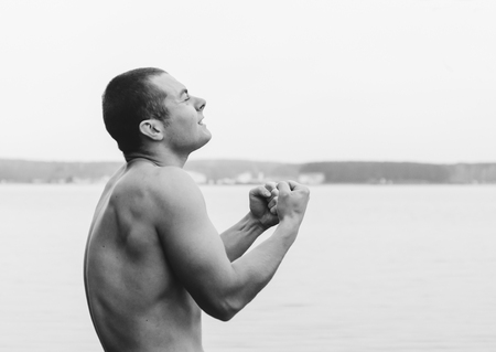 Black and white photo of the screaming man on lakeの写真素材