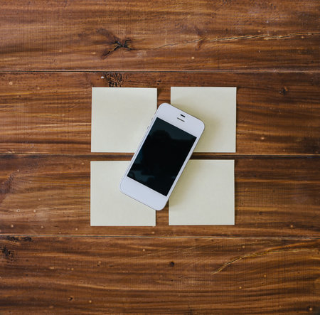 Phone and note sticks on the wood office table