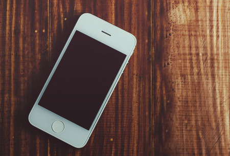 Phone mock-up on the wooden rustic office tableの写真素材