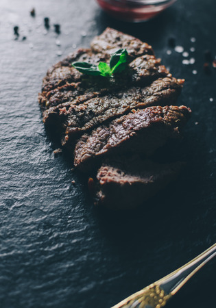 Meat steak and basil on wood rustic tableの写真素材