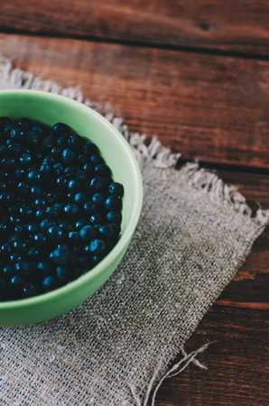 Blueberry in plate on wooden rustic kitchen tableの写真素材