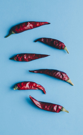 Red dry hot peppers on the blue backgroundの写真素材