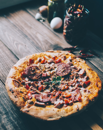 Home made pizza on the wood rustic backgroundの写真素材