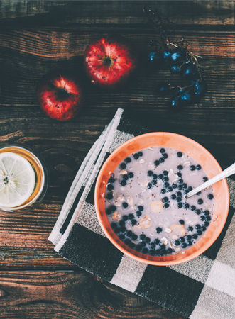 Bowl of muesli and yogurt with fresh grape and applesの写真素材