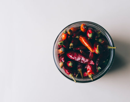 Red hot chile pepper in the glass bottleの写真素材