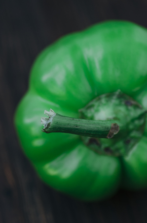 Green bell pepper on the wood rustic tableの写真素材