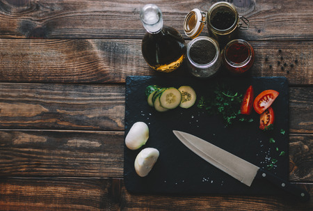 Vegetables, oil and spices on wooden rustic kitchen tableの写真素材