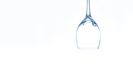 Water in wineglass on white and blue backgroundの写真素材