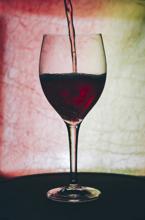 Glass with red wine on the bar tableの写真素材