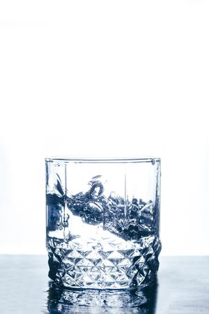 Glass of water on the white isolated backgroundの写真素材