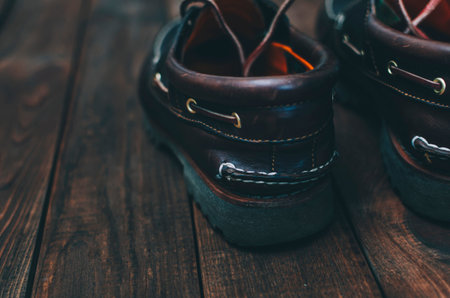 Dark brown top-siders on the wooden rustic table