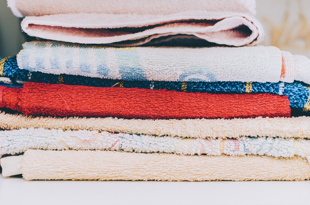 Stack of color towels in home roomの写真素材