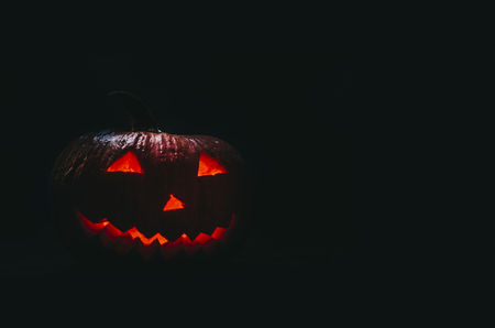 Halloween pumpkins and candles in dark and smokeの写真素材