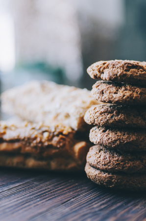 Eclairs and cookies with tea cup on wooden rustic tableの写真素材