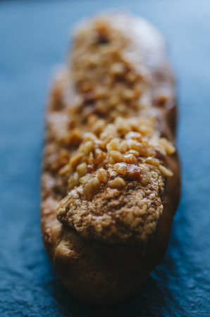 Eclairs on the black stone background with teaの写真素材