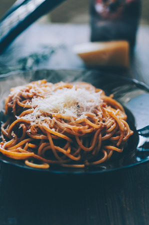 Pasta woth tomaties, cheese on the wooden rustic tableの写真素材