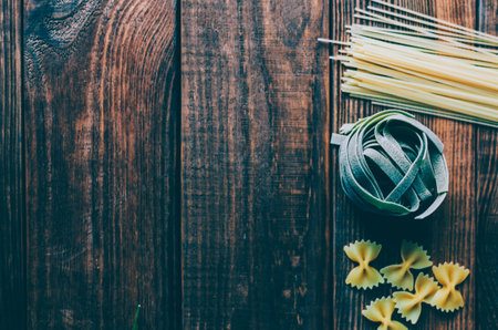 Pasta on the wood rustic kitchen tableの写真素材