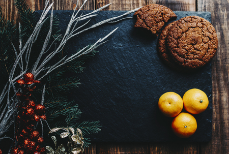 Cookies and orange on the black stone backgroundの写真素材