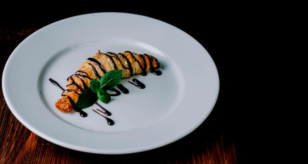 Croissant with chocolate on plate on home kitchen tableの写真素材