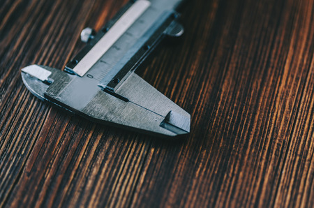 Caliper tool on wooden rustic tableの写真素材