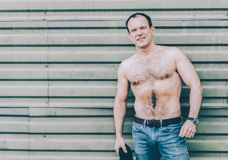 40s pretty man staying near the green wallの写真素材