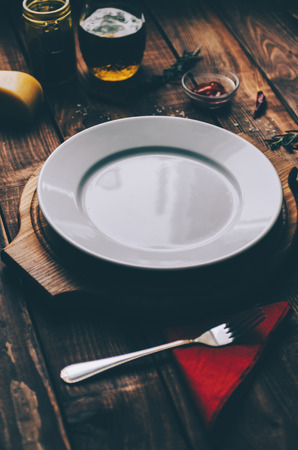 Empty plate on the home wooden rustic tableの写真素材
