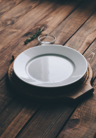 Empty plate on the home wooden rustic tableの写真素材