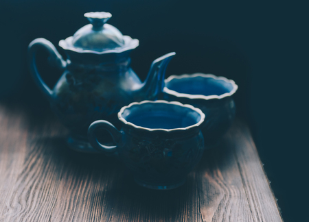 Tea cup and teapot on wooden tableの写真素材