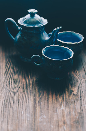 Tea cup and teapot on wooden tableの写真素材