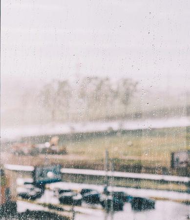 Water drops after rain and bokeh on the home windowの写真素材