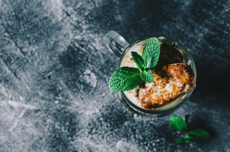 Homemade tiramisu in glas on black marble backgroundの写真素材