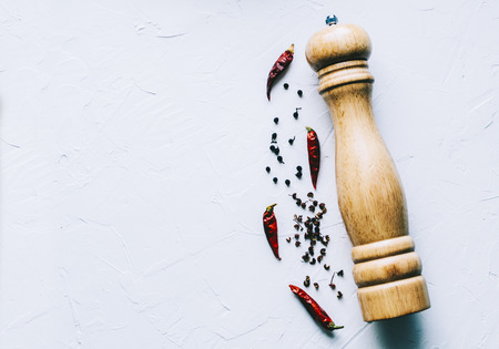 Wooden pepper mill on kitchen tableの写真素材