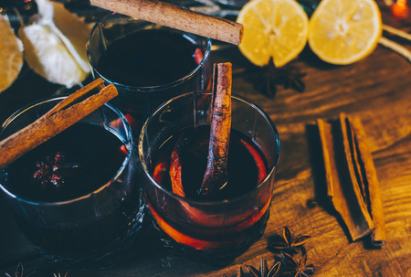 Glasses with mulled wine in christmas time on wooden tableの写真素材