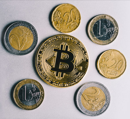 Bitcoin styled coin with international currency banknotes and Euro moneyの写真素材