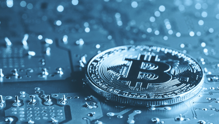 Golden Bitcoin Cryptocurrency on computer circuit board. Macro shotの写真素材