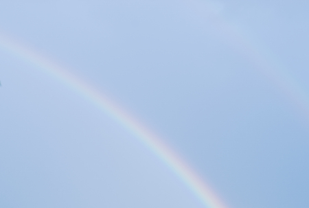 Rainbow in sky after rain in autumn timeの写真素材