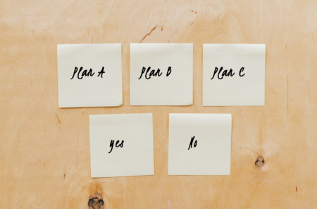 Paper notes on wooden wall backgroundの写真素材